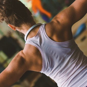 A person doing a standing shoulder press