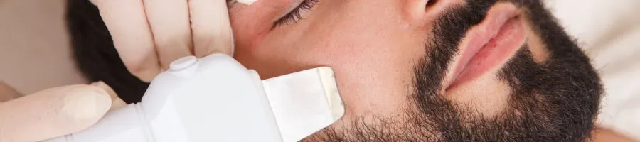 Close up of a man being treated for acne