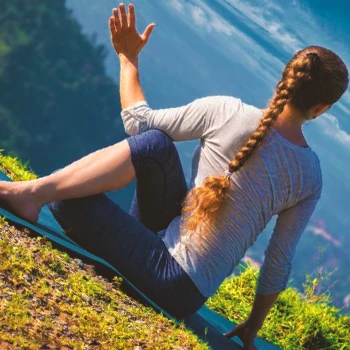 A person doing two knee spinal twist workouts