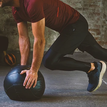 A person at the gym working out with a ball