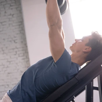 man working out while laying on a bench