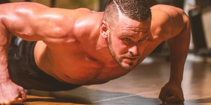 A man doing intense lower chest push up