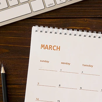 Calendar resting on a table with pen