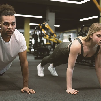 Partners working out in gym