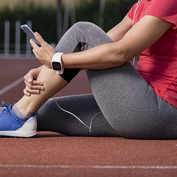 Woman resting on ground after working out