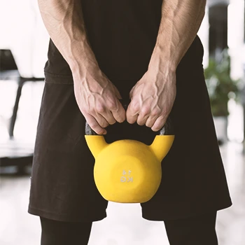 A person lifting kettle ball