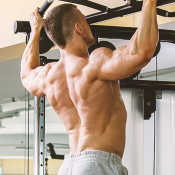 Man doing pull ups to progress in bro split