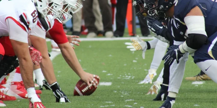 The two football team players are facing each other.