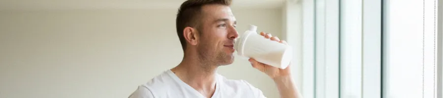 Derek drinking protein shake in the morning