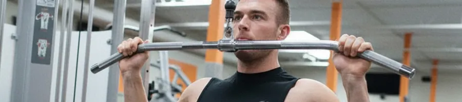 Derek doing a lat pulldown in the gym