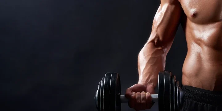 A man lifting dumbbell and was flexing his muscles