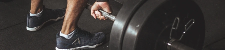 A man lifting barbell at the gym