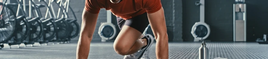 A man doing mountain climbers in his workout routine