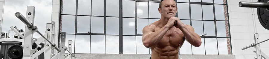 Luke Evans doing a squat workout