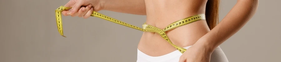 A woman measuring her waist