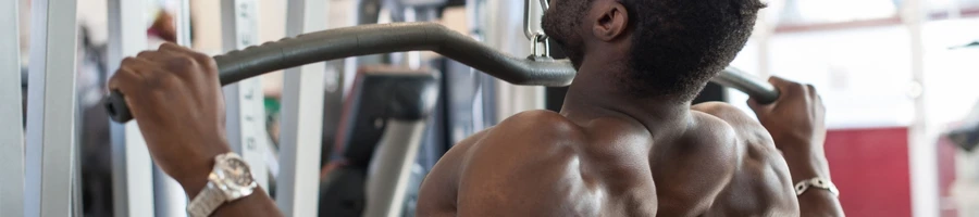 A man doing pull ups in the gym