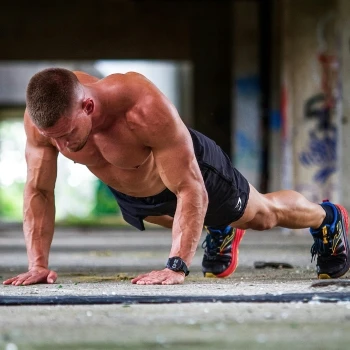 A man doing push ups at the park
