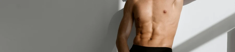 A topless man showing his abs