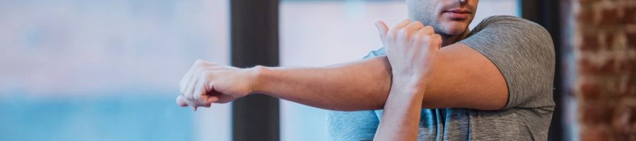 A man was stretching getting ready for his workout routine