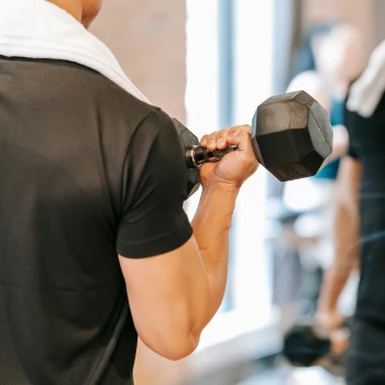 A guy using dumbbell in his workout