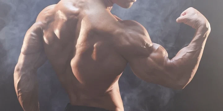A man flexing his muscles with smoke effect