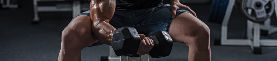 A man doing seated dumbbell curls