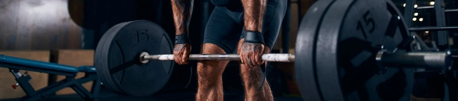 A man holding a barbell in the gym