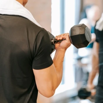 A guy working out in front of the mirror