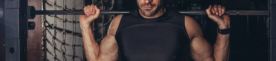 A man holding a barbell on his shoulders